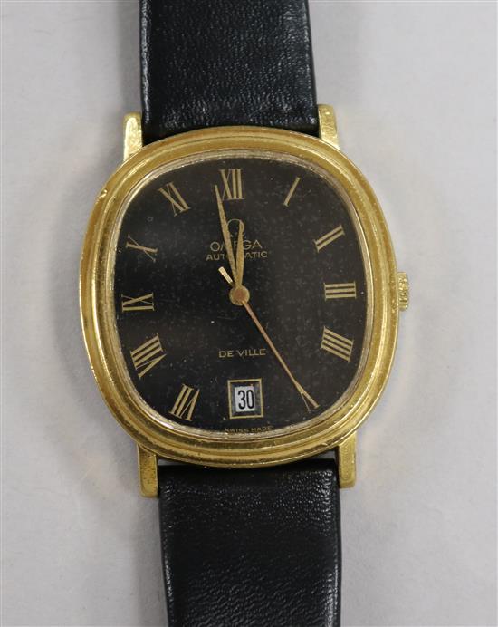 A gentlemans gold plated and steel Omega De Ville automatic wrist watch.